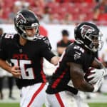 Quarterback Josh Rosen #16 of the Atlanta Falcons hands off the ball to Mike Davis #28 in the fourth quarter of the game against the Tampa Bay Buccaneers at Raymond James Stadium on September 19, 2021 in Tampa, Florida.