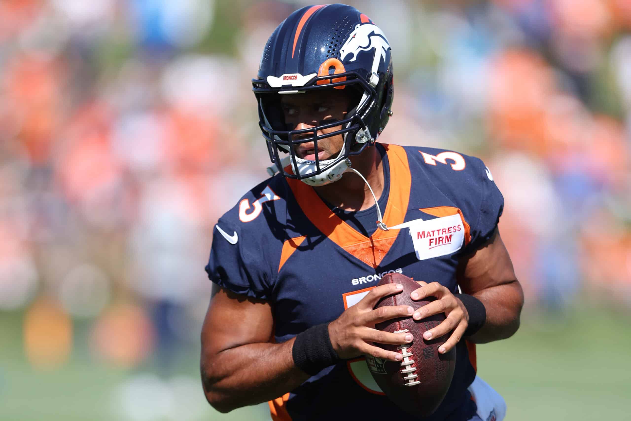 Quarterback Russell Wilson #3 of the Denver Broncos practices with his team during training camp at UCHealth Training Center on July 27, 2022 in Englewood, Colorado.