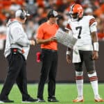 Head coach Kevin Stefanski of the Cleveland Browns talks with Jacoby Brissett #7 during the first half of a preseason game against the Chicago Bears at FirstEnergy Stadium on August 27, 2022 in Cleveland, Ohio.