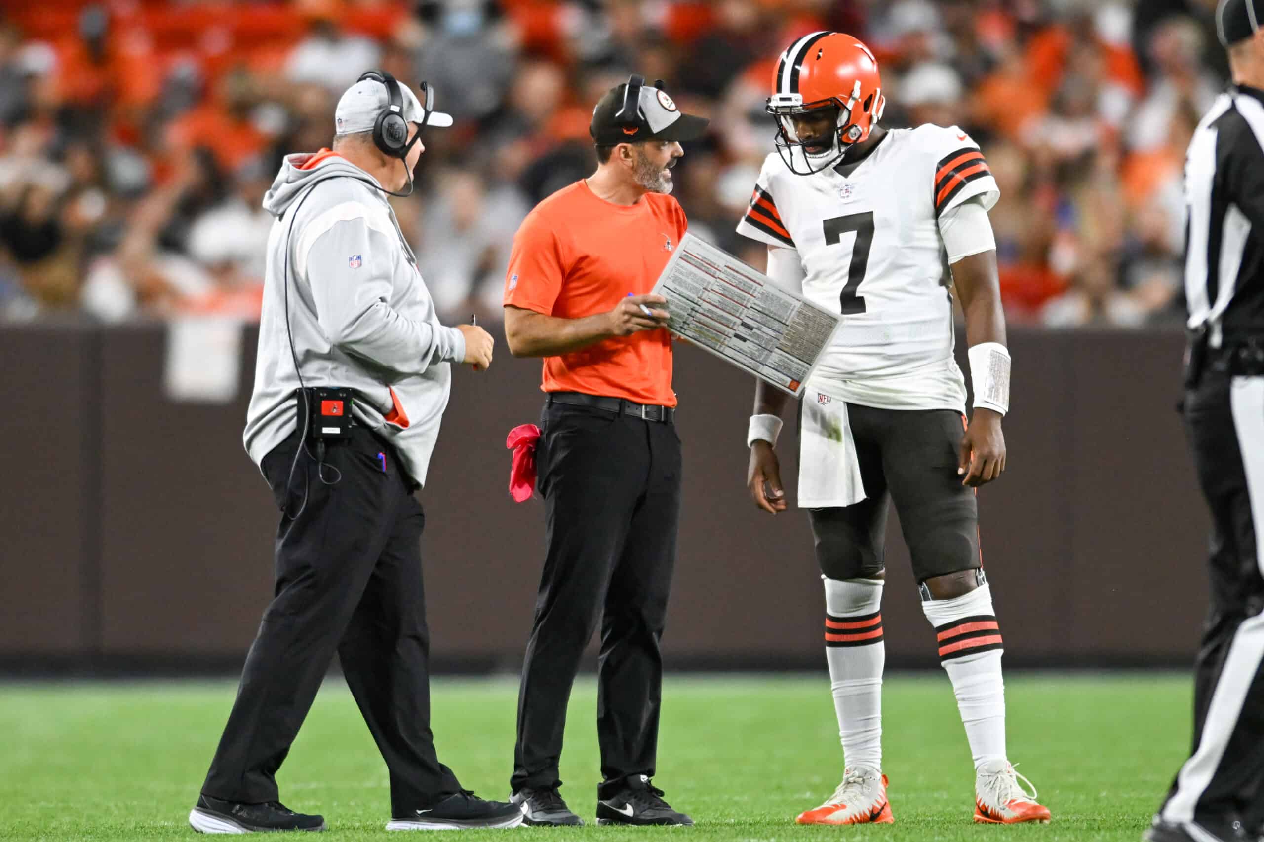 Head coach Kevin Stefanski of the Cleveland Browns talks with Jacoby Brissett #7 during the first half of a preseason game against the Chicago Bears at FirstEnergy Stadium on August 27, 2022 in Cleveland, Ohio.