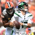 Myles Garrett #95 of the Cleveland Browns hits Joe Flacco #19 of the New York Jets during the second quarter at FirstEnergy Stadium on September 18, 2022 in Cleveland, Ohio.