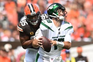 Myles Garrett #95 of the Cleveland Browns hits Joe Flacco #19 of the New York Jets during the second quarter at FirstEnergy Stadium on September 18, 2022 in Cleveland, Ohio.