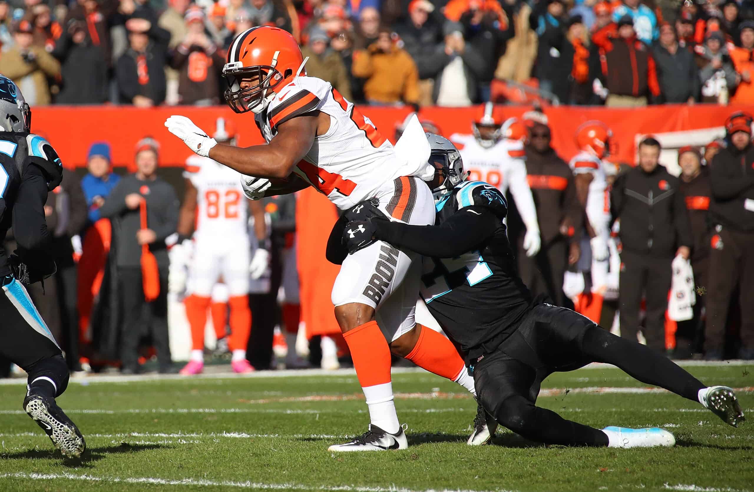 Nick Chubb #24 of the Cleveland Browns is tackled by James Bradberry #24 of the Carolina Panthers during the first quarter at FirstEnergy Stadium on December 9, 2018 in Cleveland, Ohio.