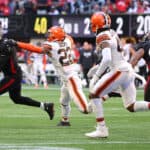 Marcus Mariota #1 of the Atlanta Falcons runs with the ball against Grant Delpit #22 of the Cleveland Browns after a bobble snap during the fourth quarter at Mercedes-Benz Stadium on October 02, 2022 in Atlanta, Georgia.