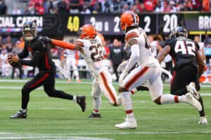 Marcus Mariota #1 of the Atlanta Falcons runs with the ball against Grant Delpit #22 of the Cleveland Browns after a bobble snap during the fourth quarter at Mercedes-Benz Stadium on October 02, 2022 in Atlanta, Georgia.