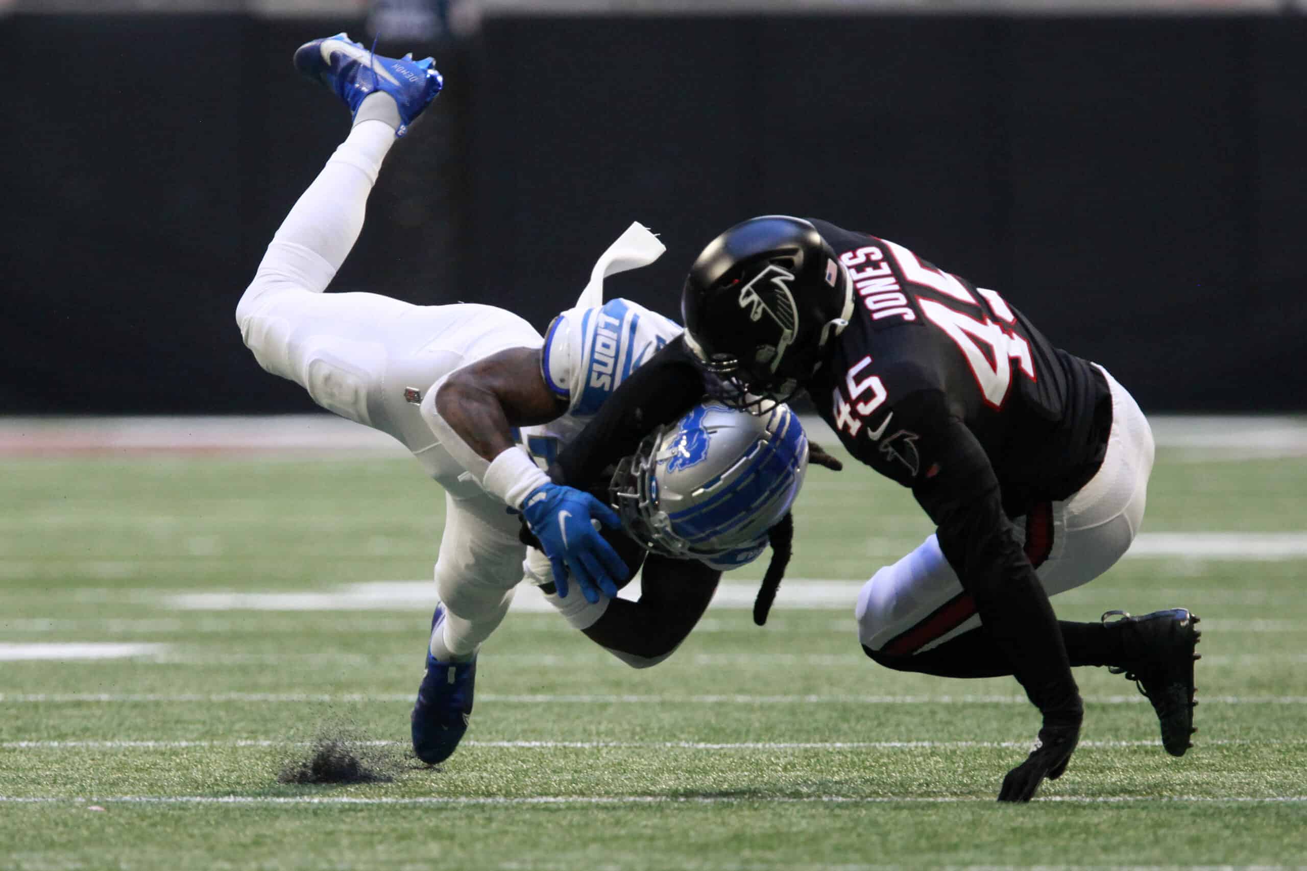 Jamaal Williams #30 of the Detroit Lions makes a catch against Deion Jones #45 of the Atlanta Falcons in the first half at Mercedes-Benz Stadium on December 26, 2021 in Atlanta, Georgia.