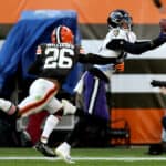 Rashod Bateman #12 of the Baltimore Ravens makes a catch against Greedy Williams #26 of the Cleveland Browns during the fourth quarter at FirstEnergy Stadium on December 12, 2021 in Cleveland, Ohio.