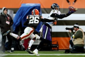 Rashod Bateman #12 of the Baltimore Ravens makes a catch against Greedy Williams #26 of the Cleveland Browns during the fourth quarter at FirstEnergy Stadium on December 12, 2021 in Cleveland, Ohio.