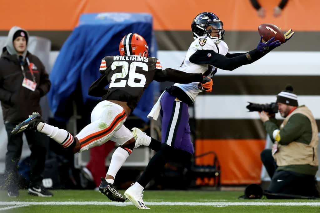 Rashod Bateman #12 of the Baltimore Ravens makes a catch against Greedy Williams #26 of the Cleveland Browns during the fourth quarter at FirstEnergy Stadium on December 12, 2021 in Cleveland, Ohio.