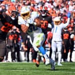 Grant Delpit #22 of the Cleveland Browns tackles Austin Ekeler #30 of the Los Angeles Chargers while scoring a touchdown during the third quarter at FirstEnergy Stadium on October 09, 2022 in Cleveland, Ohio.