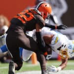 Grant Delpit #22 of the Cleveland Browns tackles Austin Ekeler #30 of the Los Angeles Chargers while scoring a touchdown during the third quarter at FirstEnergy Stadium on October 09, 2022 in Cleveland, Ohio.