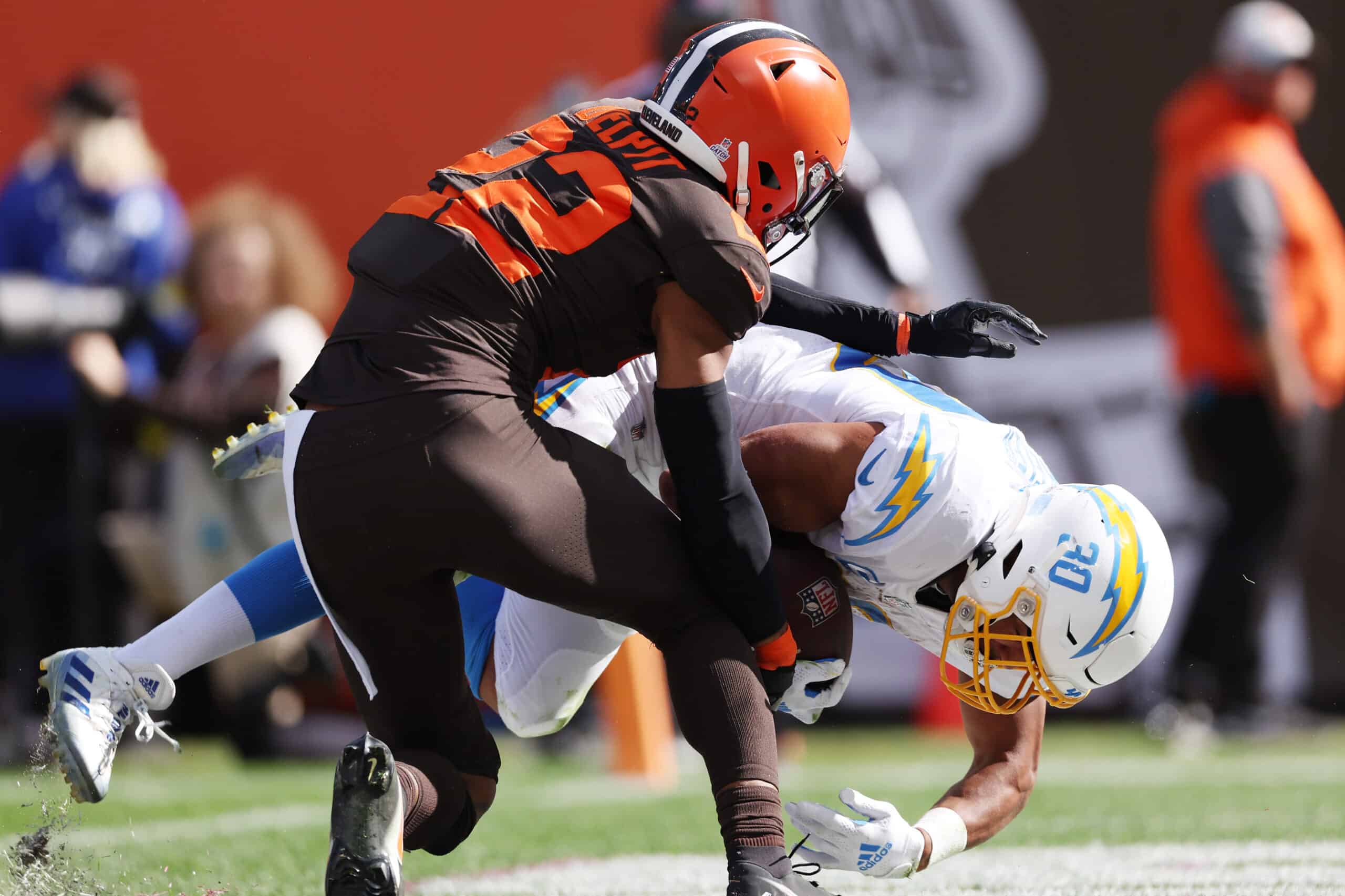 Grant Delpit #22 of the Cleveland Browns tackles Austin Ekeler #30 of the Los Angeles Chargers while scoring a touchdown during the third quarter at FirstEnergy Stadium on October 09, 2022 in Cleveland, Ohio.