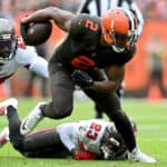 Amari Cooper #2 of the Cleveland Browns runs with the ball as Devin White #45 and Sean Murphy-Bunting #23 of the Tampa Bay Buccaneers defend during the first half at FirstEnergy Stadium on November 27, 2022 in Cleveland, Ohio.