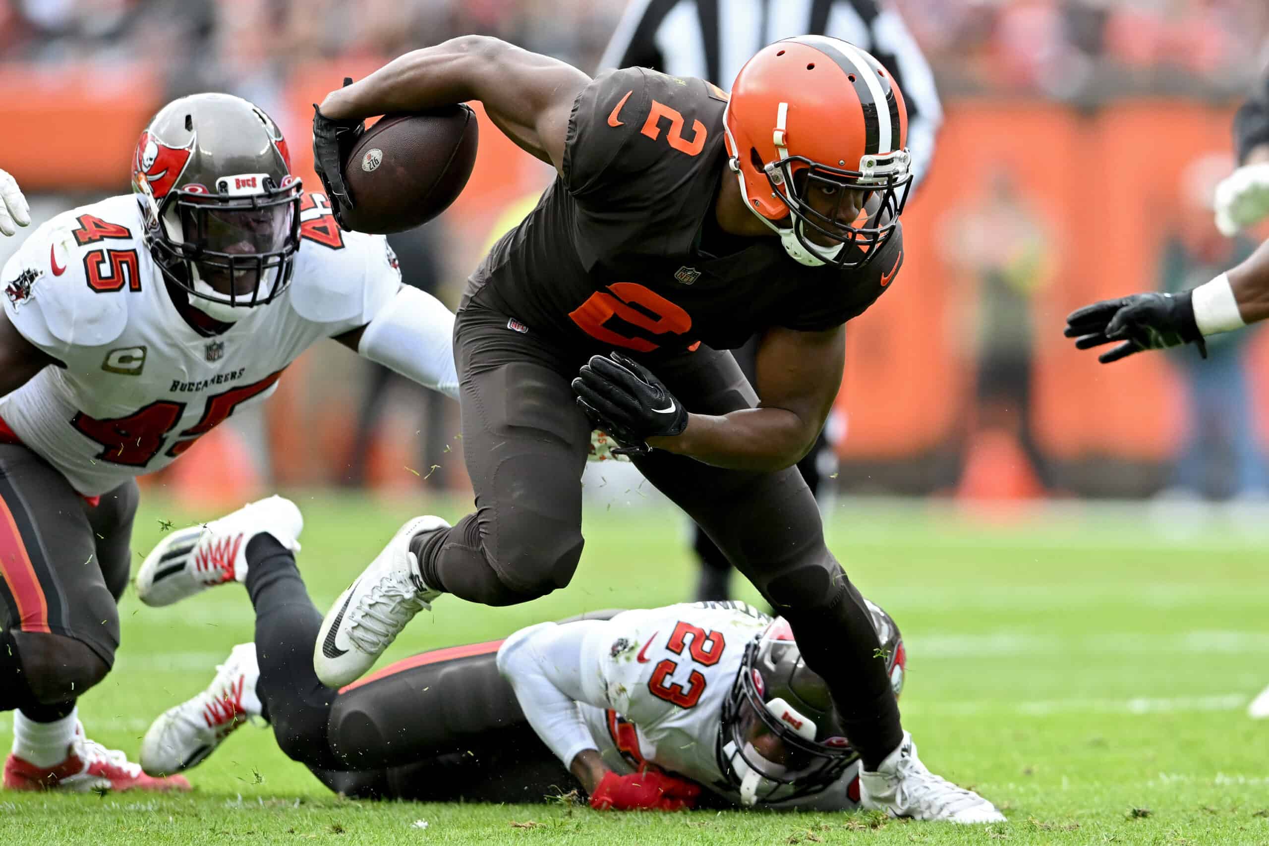 Amari Cooper #2 of the Cleveland Browns runs with the ball as Devin White #45 and Sean Murphy-Bunting #23 of the Tampa Bay Buccaneers defend during the first half at FirstEnergy Stadium on November 27, 2022 in Cleveland, Ohio. 