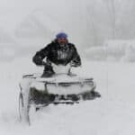 HAMBURG, NY - November 18: Robert Skimin uses an ATV to dig out after an intense lake-effect snowstorm impacted the area on November 18, 2022 in Hamburg, New York. Around Buffalo and the surrounding suburbs, the snowstorm resulted in up to four feet of accumulation, and additional snowfall is forecast for the weekend.