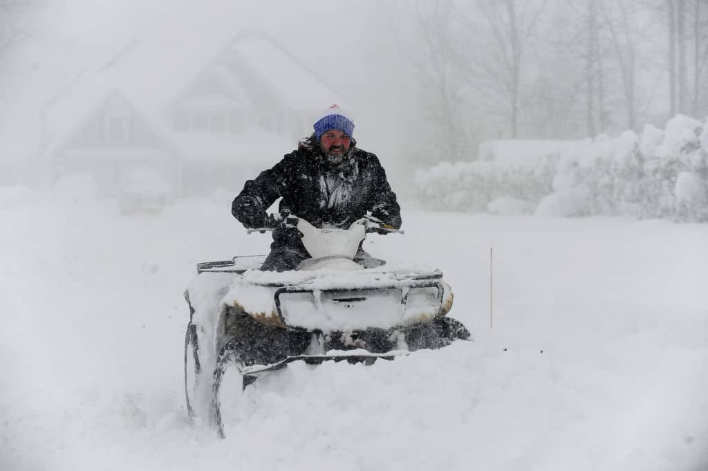 HAMBURG, NY - November 18: Robert Skimin uses an ATV to dig out after an intense lake-effect snowstorm impacted the area on November 18, 2022 in Hamburg, New York. Around Buffalo and the surrounding suburbs, the snowstorm resulted in up to four feet of accumulation, and additional snowfall is forecast for the weekend.