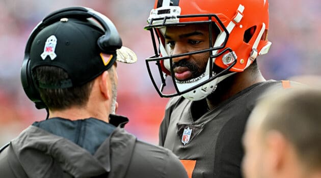 Jacoby Brissett #7 of the Cleveland Browns talks to head coach Kevin Stefanski during the first half against the Tampa Bay Buccaneers at FirstEnergy Stadium on November 27, 2022 in Cleveland, Ohio.
