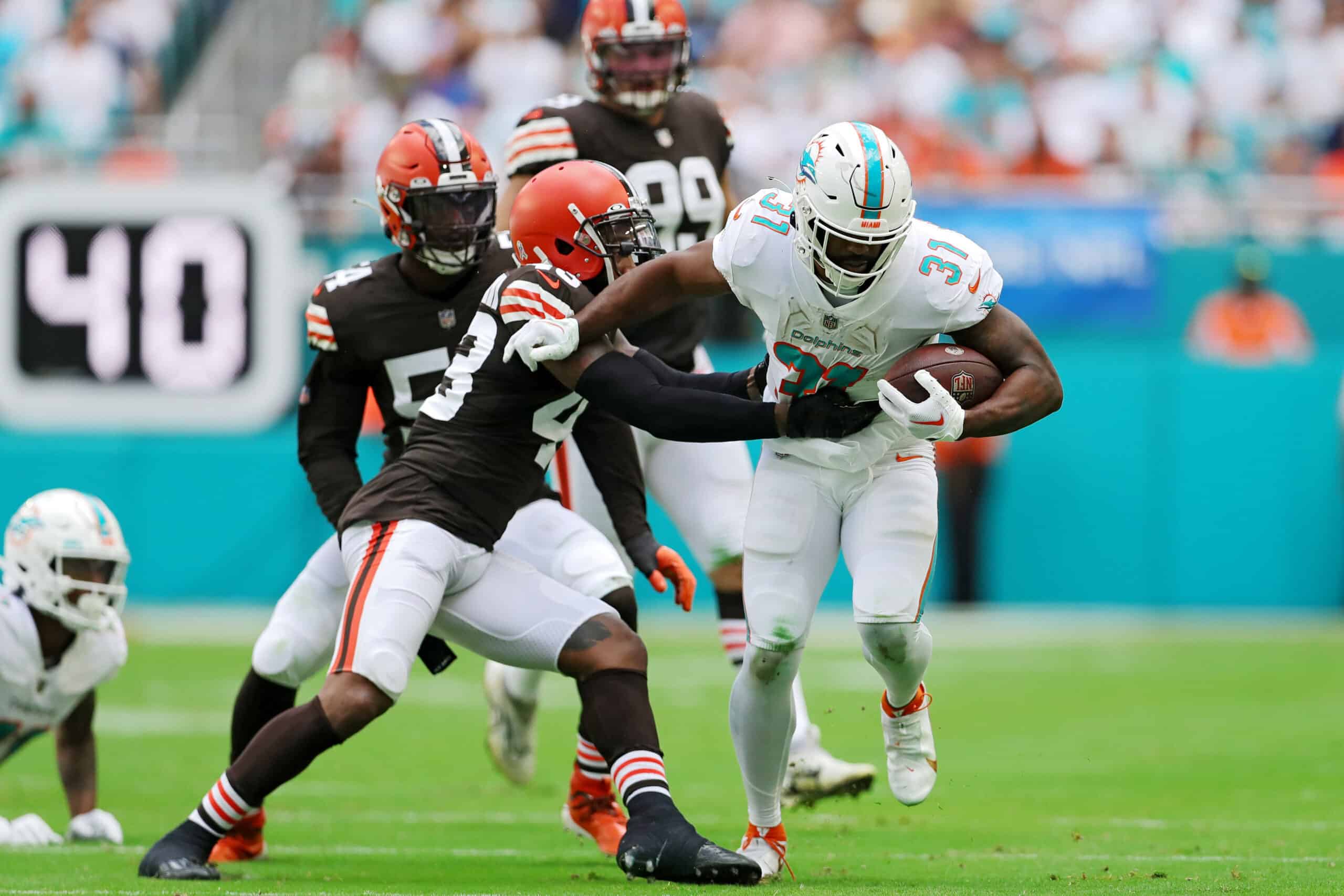 Raheem Mostert #31 of the Miami Dolphins rushes whilst being tackled by John Johnson III #43 of the Cleveland Browns in the second quarter of the game at Hard Rock Stadium on November 13, 2022 in Miami Gardens, Florida.