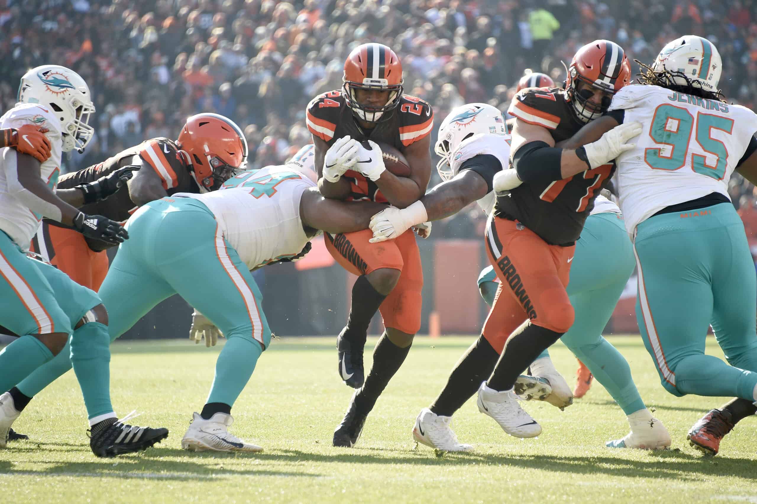 Running back Nick Chubb #24 of the Cleveland Browns finds a hole in the Miami Dolphins line during the first half at FirstEnergy Stadium on November 24, 2019 in Cleveland, Ohio. 