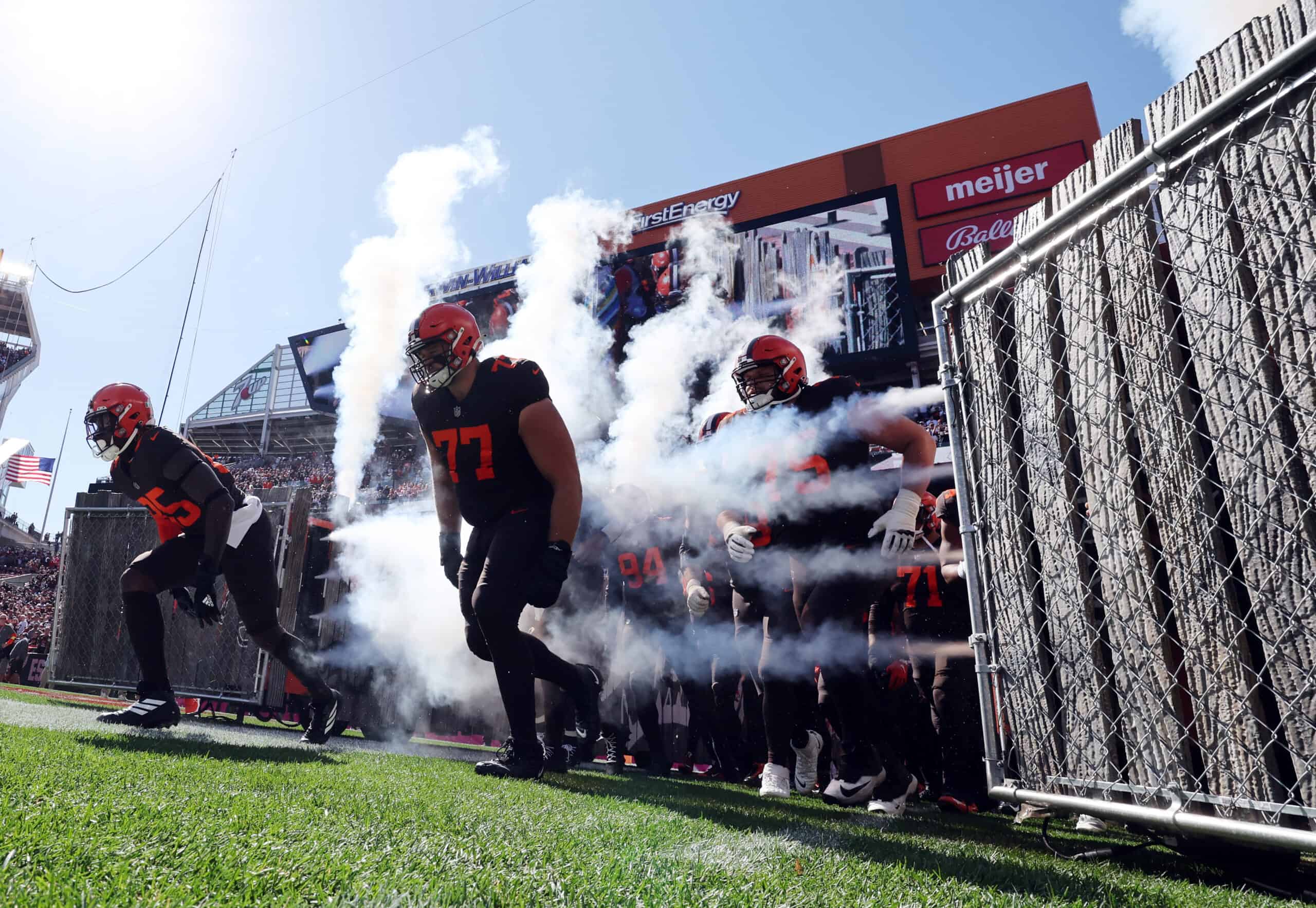 Wyatt Teller #77 of the Cleveland Browns runs on to the field with teammates prior to the game against the Los Angeles Chargers at FirstEnergy Stadium on October 09, 2022 in Cleveland, Ohio. 