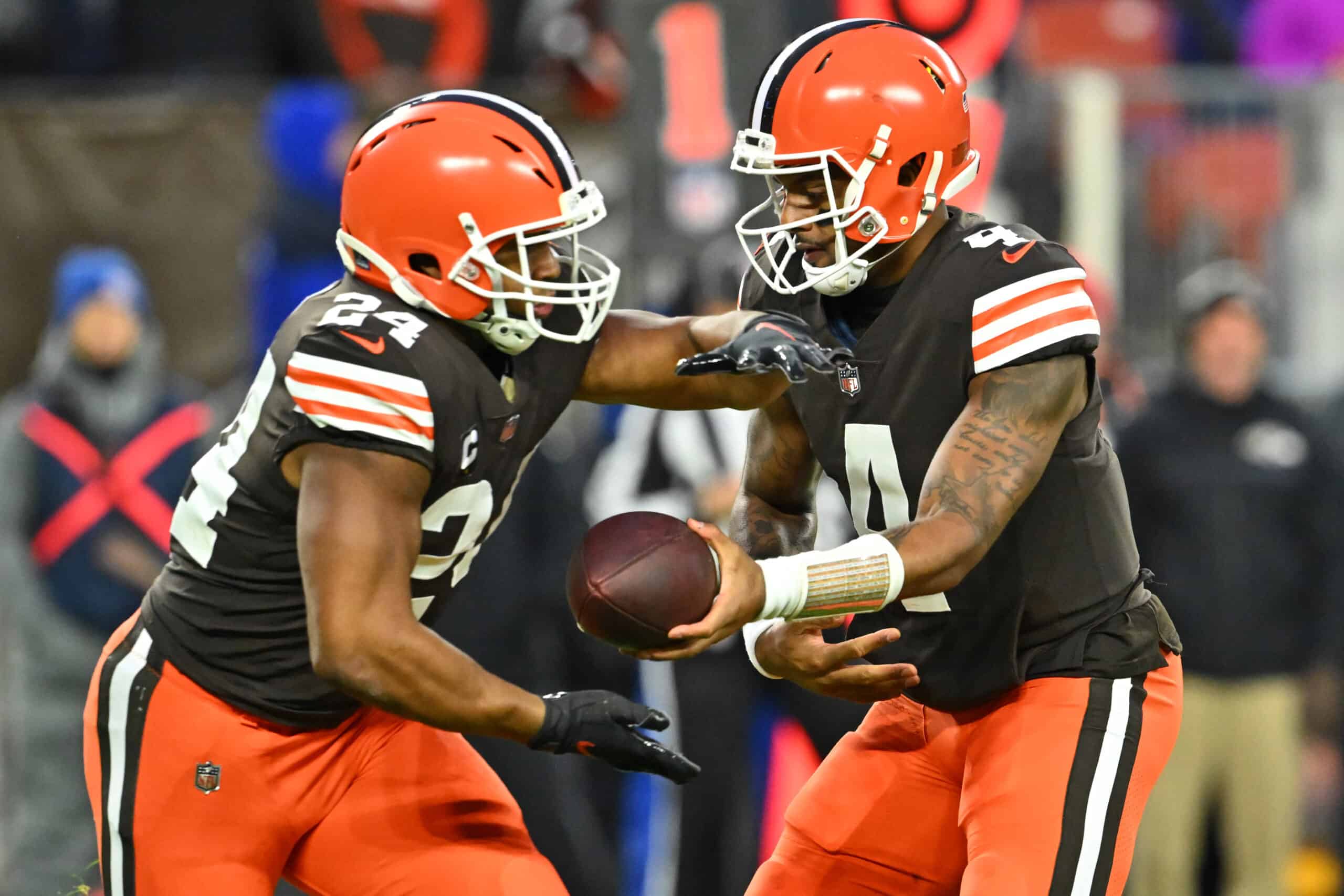 Deshaun Watson #4 of the Cleveland Browns hands the ball off to Nick Chubb #24 during the first quarter against the Baltimore Ravens at FirstEnergy Stadium on December 17, 2022 in Cleveland, Ohio.