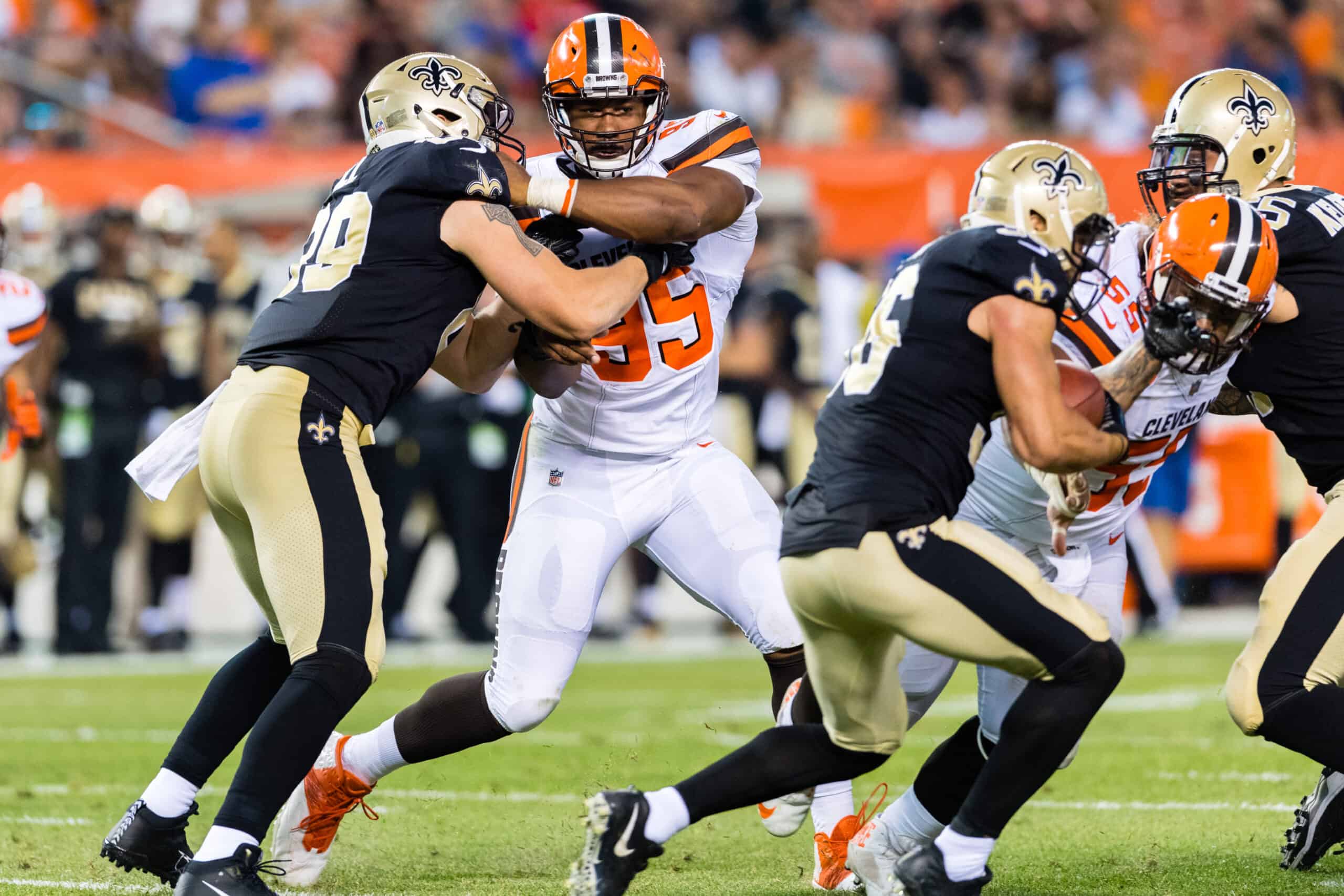 Tight end Josh Hill #89 of the New Orleans Saints blocks defensive end Myles Garrett #95 of the Cleveland Browns during the first half of a preseason game at FirstEnergy Stadium on August 10, 2017 in Cleveland, Ohio.