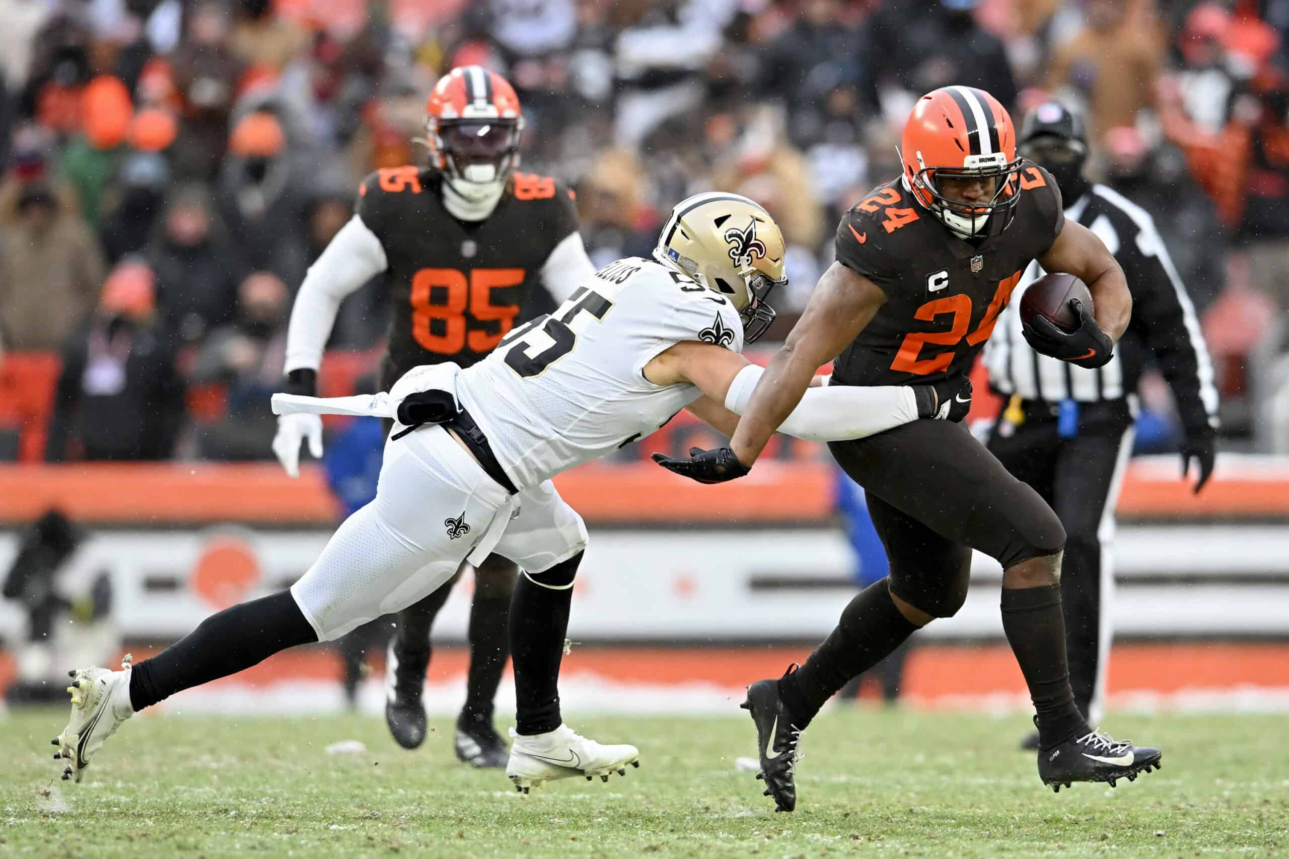 Kaden Elliss #55 of the New Orleans Saints tackles Nick Chubb #24 of the Cleveland Browns during the second half of the game at FirstEnergy Stadium on December 24, 2022 in Cleveland, Ohio.