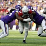 Darrel Williams #24 of the Arizona Cardinals is tackled by Za'Darius Smith #55 of the Minnesota Vikings and Dalvin Tomlinson #94 during the second quarter at U.S. Bank Stadium on October 30, 2022 in Minneapolis, Minnesota.