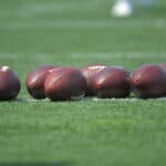BEREA, OHIO - JULY 28: Footballs lay on the field during the first day of Cleveland Browns Training Camp on July 28, 2021 in Berea, Ohio.