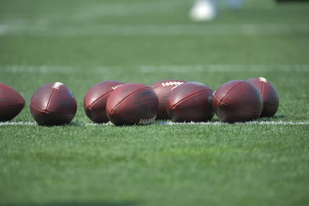 BEREA, OHIO - JULY 28: Footballs lay on the field during the first day of Cleveland Browns Training Camp on July 28, 2021 in Berea, Ohio.