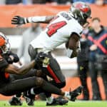 Chris Godwin #14 of the Tampa Bay Buccaneers scores a touchdown as Denzel Ward #21 of the Cleveland Browns defends during the first half at FirstEnergy Stadium on November 27, 2022 in Cleveland, Ohio.