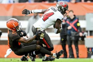 Chris Godwin #14 of the Tampa Bay Buccaneers scores a touchdown as Denzel Ward #21 of the Cleveland Browns defends during the first half at FirstEnergy Stadium on November 27, 2022 in Cleveland, Ohio.