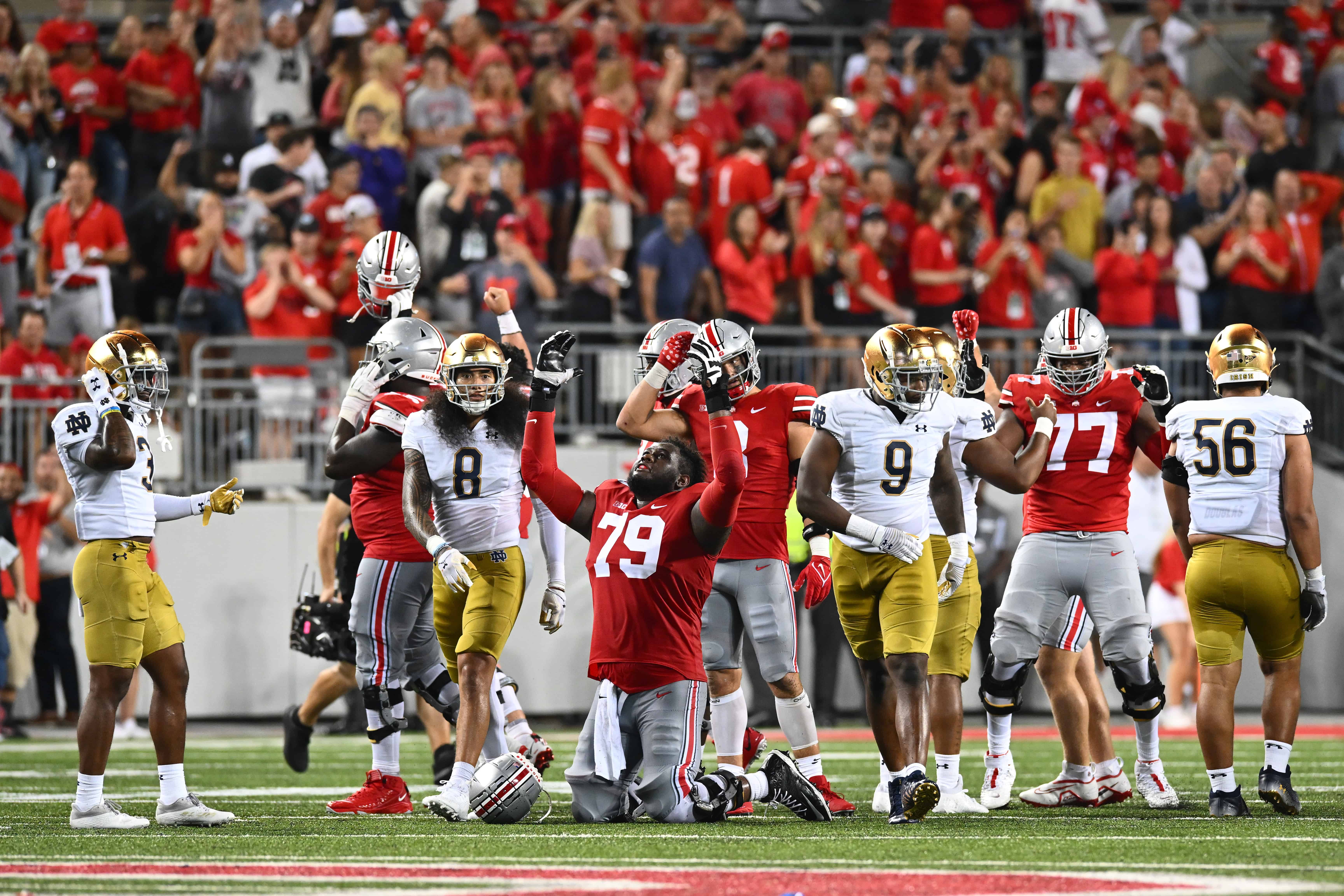 Dawand Jones #79 of the Ohio State Buckeyes falls to his knees in celebration after defeating the Notre Dame Fighting Irish 21-10 in a game at Ohio Stadium on September 03, 2022 in Columbus, Ohio.