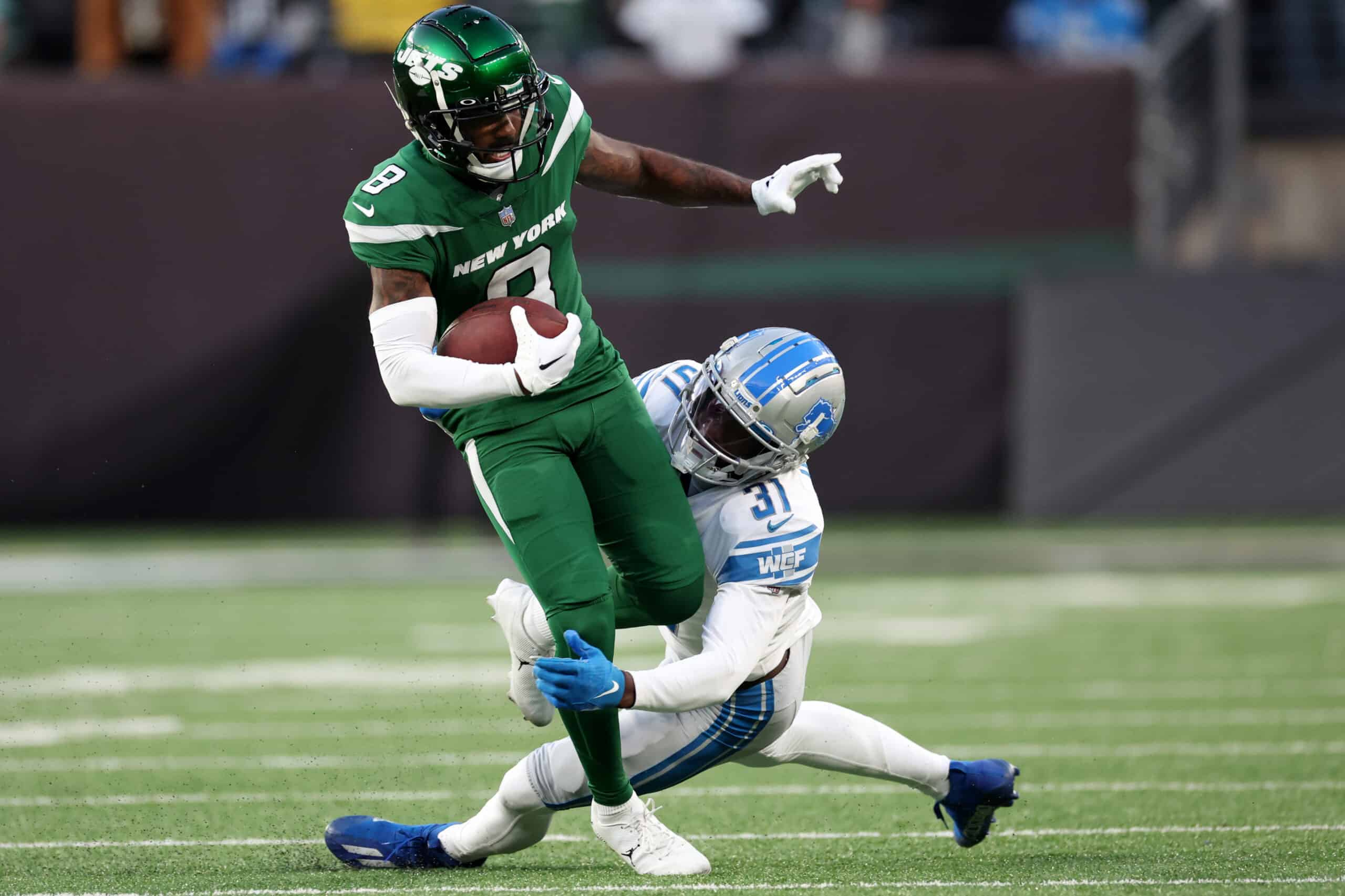 Elijah Moore #8 of the New York Jets carries the ball during the second half of the game against the Detroit Lions at MetLife Stadium on December 18, 2022 in East Rutherford, New Jersey.