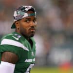 Elijah Moore #8 of the New York Jets looks on from the sidelines against the Philadelphia Eagles in the second half of the preseason game at Lincoln Financial Field on August 12, 2022 in Philadelphia, Pennsylvania. The Jets defeated the Eagles 24-21.