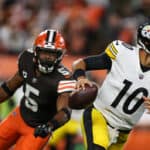 Mitch Trubisky #10 of the Pittsburgh Steelers scrambles from Anthony Walker Jr. #5 of the Cleveland Browns during the first quarter at FirstEnergy Stadium on September 22, 2022 in Cleveland, Ohio.