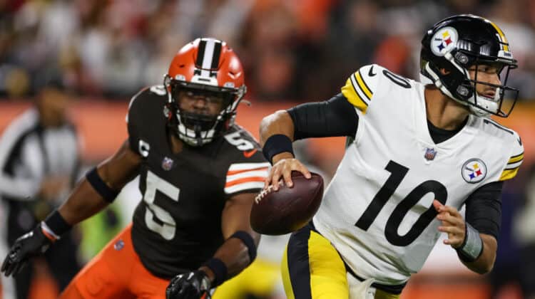 Mitch Trubisky #10 of the Pittsburgh Steelers scrambles from Anthony Walker Jr. #5 of the Cleveland Browns during the first quarter at FirstEnergy Stadium on September 22, 2022 in Cleveland, Ohio.