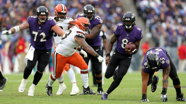 Quarterback Lamar Jackson #8 of the Baltimore Ravens runs with the ball against the Cleveland Browns at M&T Bank Stadium on October 23, 2022 in Baltimore, Maryland.