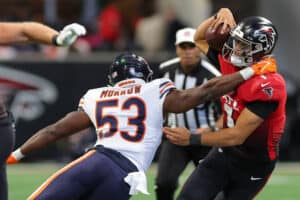 Nicholas Morrow #53 of the Chicago Bears tackles Marcus Mariota #1 of the Atlanta Falcons during the third quarter at Mercedes-Benz Stadium on November 20, 2022 in Atlanta, Georgia.