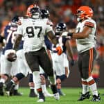 Perrion Winfrey #97 and Tommy Togiai #93 of the Cleveland Browns celebrate a fumble recover by Winfrey during the first half of a preseason game against the Chicago Bears at FirstEnergy Stadium on August 27, 2022 in Cleveland, Ohio.