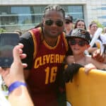 Former member of the Cleveland Browns Josh Cribbs poses with a fan during the Cleveland Cavaliers 2016 NBA Championship victory parade and rally on June 22, 2016 in Cleveland, Ohio.