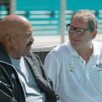 Former Cleveland Browns quarterback Bernie Kosar talks with Hall of Fame running back Jim Brown before the start of the game against the Miami Dolphins on September 25, 2016 in Miami Gardens, Florida.