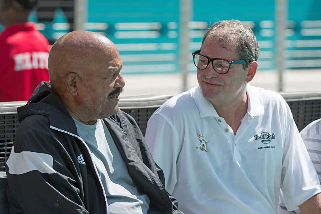 Former Cleveland Browns quarterback Bernie Kosar talks with Hall of Fame running back Jim Brown before the start of the game against the Miami Dolphins on September 25, 2016 in Miami Gardens, Florida.