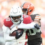 Greg Newsome II #20 of the Cleveland Browns tackles DeAndre Hopkins #10 of the Arizona Cardinals after a catch during the second quarter at FirstEnergy Stadium on October 17, 2021 in Cleveland, Ohio.