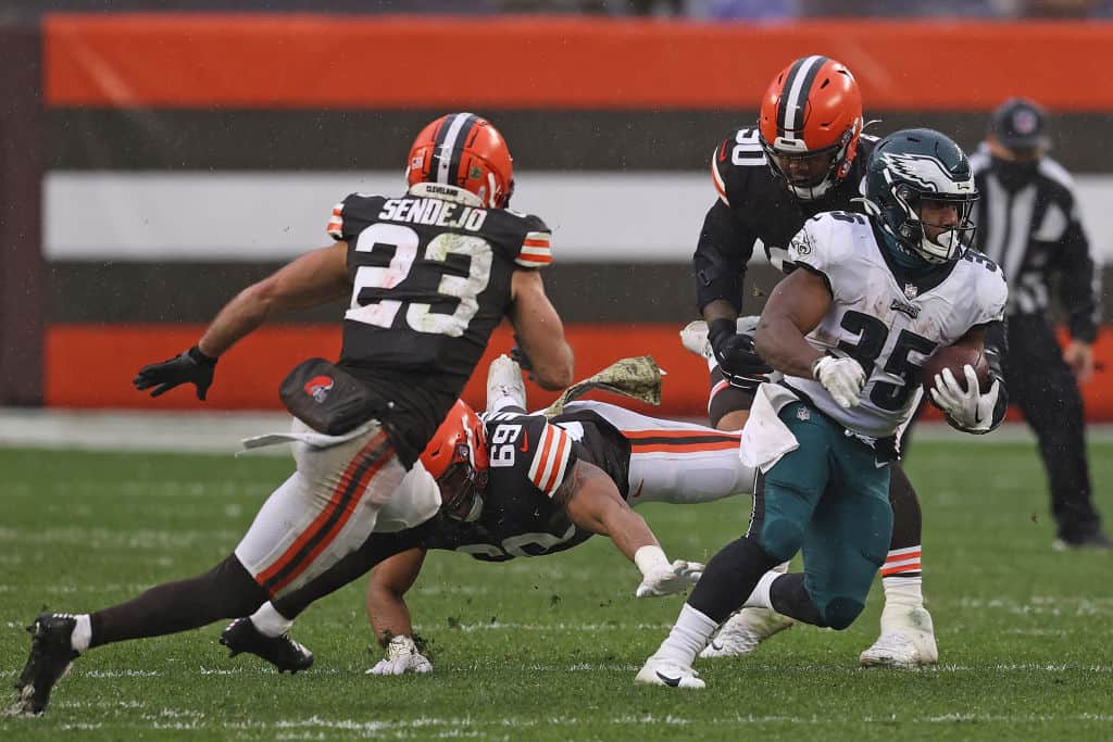 Boston Scott #35 of the Philadelphia Eagles is pursued by Andrew Sendejo #23 of the Cleveland Browns during the first half at FirstEnergy Stadium on November 22, 2020 in Cleveland, Ohio.