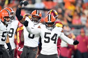 Linebacker Jeremiah Owusu-Koramoah #6 and defensive end Ogbo Okoronkwo #54 of the Cleveland Browns celebrate a stop during the first half of a preseason game against the Washington Commanders at Cleveland Browns Stadium on August 11, 2023 in Cleveland, Ohio.