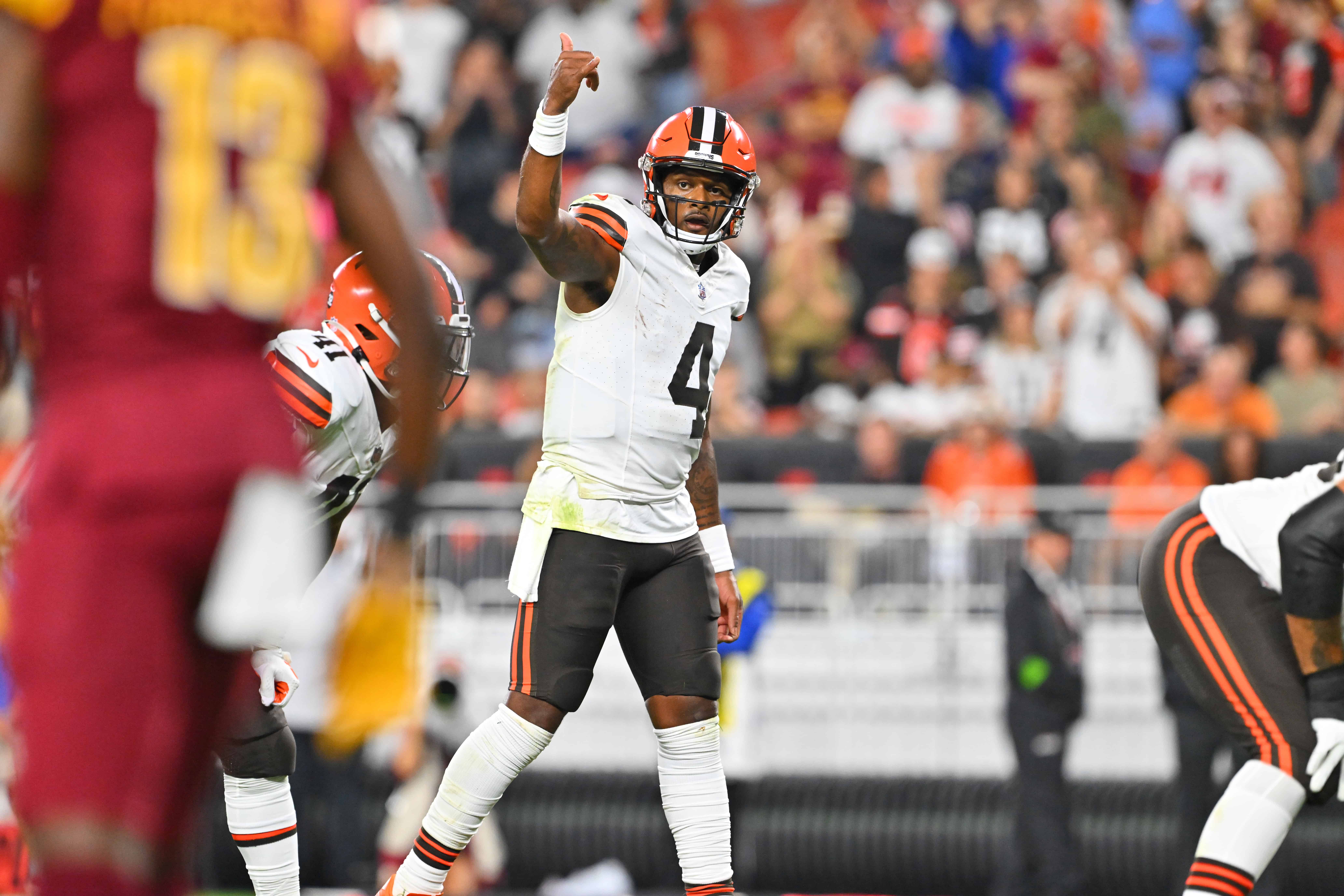 Deshaun Watson #4 of the Cleveland Browns signals to his teammates during the first half of a preseason game against the Washington Commanders at Cleveland Browns Stadium on August 11, 2023 in Cleveland, Ohio.