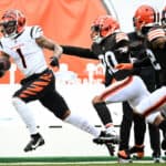 Ja'Marr Chase #1 of the Cincinnati Bengals runs the ball as Greg Newsome II #20 of the Cleveland Browns attempts to make the tackle during the first half at FirstEnergy Stadium on January 09, 2022 in Cleveland, Ohio.