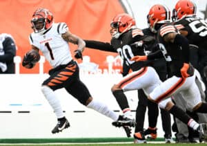Ja'Marr Chase #1 of the Cincinnati Bengals runs the ball as Greg Newsome II #20 of the Cleveland Browns attempts to make the tackle during the first half at FirstEnergy Stadium on January 09, 2022 in Cleveland, Ohio.