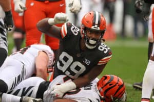 Za'Darius Smith #99 of the Cleveland Browns celebrates a tackle on Joe Mixon #28 of the Cincinnati Bengals during the first half at Cleveland Browns Stadium on September 10, 2023 in Cleveland, Ohio.